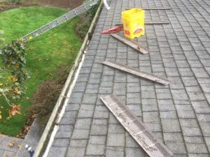 A gutter that has been cleaned and is being worked on.