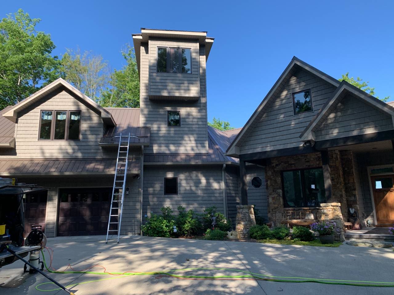 A large house with a ladder up to the top of it.