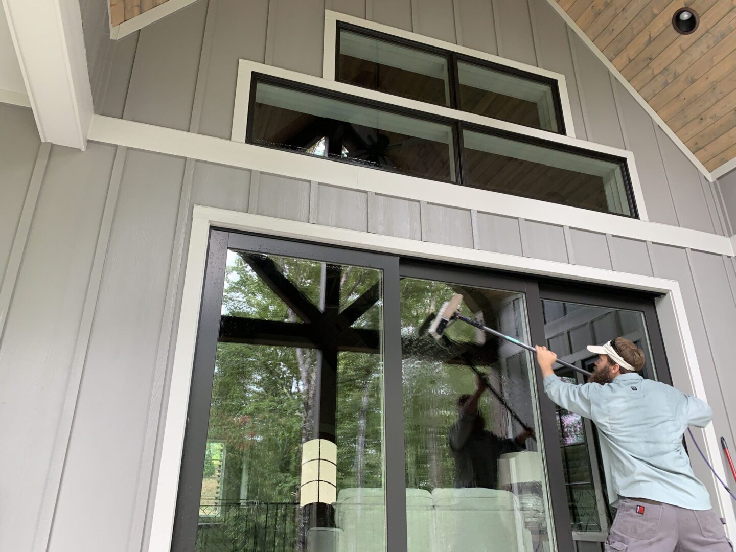 A man is standing in front of a window.